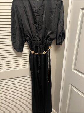 Elegant Black Jumpsuit with Decorative Gold Chain Belt